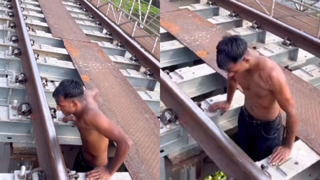Dangerous Stunts On Railway Track Youth Hangs From Railway Bridge Video Goes Viral