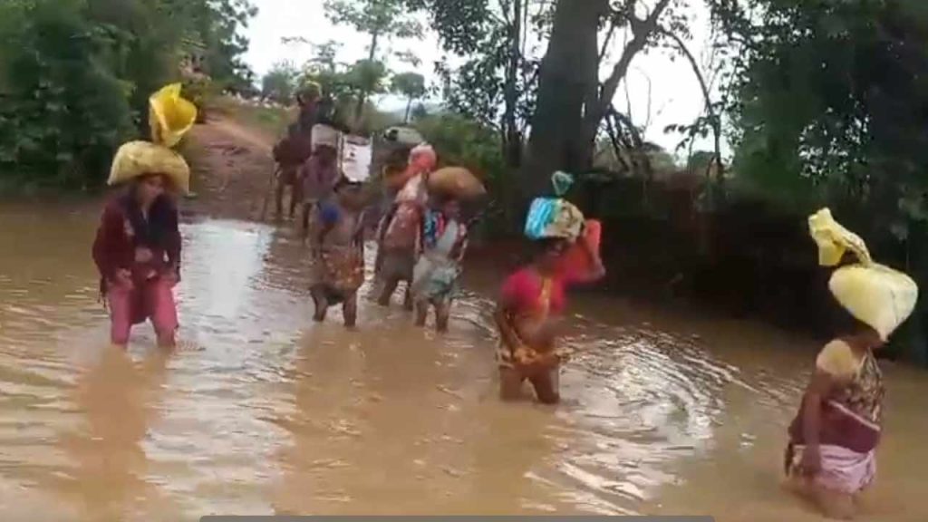 Mulugu Kalipaka Tribals Crossing Stream Rainy Season